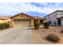 Charming single-story home with a two-car garage, desert landscaping and a cozy covered porch entrance at 749 E Desert Moon Trl, San Tan Valley, AZ 85143
