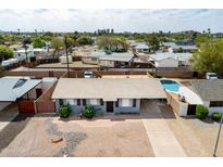 An aerial view of the home, featuring a private pool and well-kept gravel yard at 7513 E Roosevelt St, Scottsdale, AZ 85257