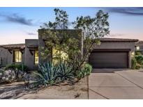Inviting home showcasing desert landscaping, a two-car garage, and a warm, neutral color palette at 9270 E Thompson Peak Pkwy # 315, Scottsdale, AZ 85255