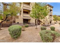Attractive exterior of a multi-story building with well maintained landscaping, manicured bushes and decorative gravel at 10136 E Southern Ave # 1074, Mesa, AZ 85209