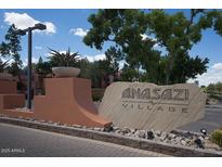 A welcoming stone sign for the Anasazi Village community amid lush greenery at 12222 N Paradise Village S Pkwy # 409, Phoenix, AZ 85032