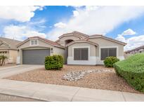 Charming single-story home featuring manicured landscaping and a neutral color palette at 1289 E Baker Dr, San Tan Valley, AZ 85140