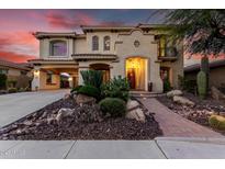 Inviting two-story home with desert landscaping and a brick walkway leading to the front entrance at 13336 W Via Caballo Blanco --, Peoria, AZ 85383