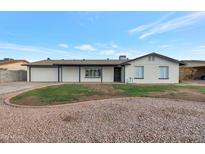 Charming single-story home with desert landscaping and a freshly painted exterior, exuding curb appeal at 1410 W Morrow Dr, Phoenix, AZ 85027