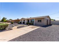 Charming single-story home with desert landscaping, gravel yard and walkway at 14842 N 36Th St, Phoenix, AZ 85032
