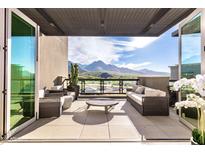 Expansive balcony featuring comfortable seating, offering breathtaking views of the surrounding desert landscape at 18720 N 101St St # 3006, Scottsdale, AZ 85255