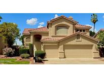 Lovely two-story home featuring a tile roof, neutral-toned exterior, an attached two-car garage, and well-maintained landscaping at 21538 N 59Th Ln, Glendale, AZ 85308