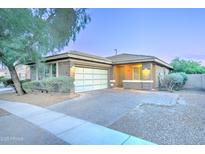 Charming single-story home with a two-car garage, brick accents, and a well-manicured front yard at 3153 E Ivanhoe St, Gilbert, AZ 85295