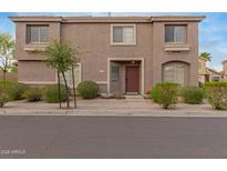 Charming two-story townhome with well-maintained landscaping and a welcoming front entrance at 4002 E Melinda Ln, Phoenix, AZ 85050