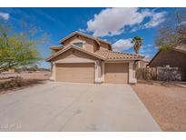 Charming two-story home with a spacious three-car garage and desert landscaping at 504 E Racine Pl, Casa Grande, AZ 85122