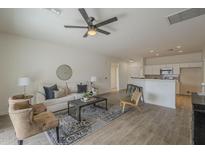Bright, neutral living room with tile floors, a ceiling fan, and an open layout at 507 W Magdalena Ln, Phoenix, AZ 85041