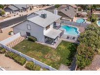 Aerial view of backyard with refreshing pool, well-kept lawn and shaded patio, perfect for outdoor living at 6237 W Altadena Ave, Glendale, AZ 85304