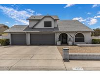 Charming home featuring a three-car garage, arched entry, and well-maintained landscaping at 6237 W Altadena Ave, Glendale, AZ 85304