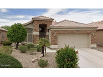 Charming single-story home with stone accents and a well-maintained front yard at 9032 W Sierra Pinta Dr, Peoria, AZ 85382