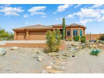 Charming desert home with a three car garage, tile roof, and desert landscaping at 15201 N Zapata Dr, Fountain Hills, AZ 85268