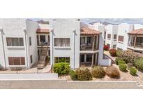 Condo complex featuring red tile roofs, stucco walls, patios, and desert landscaping against a mountain backdrop at 16616 E Gunsight Dr # 114, Fountain Hills, AZ 85268