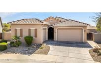 Charming single-story home featuring a tile roof, multiple garage spaces and desert landscaping at 24127 N 166Th Ct, Surprise, AZ 85387