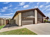 A lovely two-story home showing a two car garage with a beautiful blue sky above at 3154 E Clarendon Ave, Phoenix, AZ 85016
