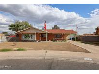Charming single-story brick home with a well-manicured front yard, flag, and covered parking at 4117 W Sierra Vista Dr, Phoenix, AZ 85019