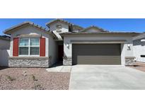 Charming single-story home featuring stone accents, desert landscaping and a two car garage at 4922 S 105Th Ln, Tolleson, AZ 85353