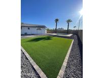 The artificial turf is surrounded by pea gravel and a view of the pool at 7637 E Akron St, Mesa, AZ 85207