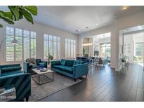 Bright, open living room features plantation shutters and contemporary furnishings at 7703 E Overlook Dr, Scottsdale, AZ 85255
