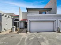 Two-story home with desert landscaping, a one-car garage, and private balcony at 8711 N 67Th Dr, Peoria, AZ 85345