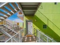 Modern building with vibrant green exterior walls and open stairway access to residences at 1111 W University Dr # 2012, Tempe, AZ 85281