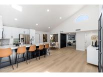 Bright, open kitchen with large island, modern stainless steel appliances, and adjacent dining area at 14542 N 91St Pl, Scottsdale, AZ 85260