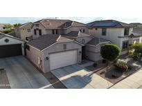 Exterior elevation of a two-story home featuring a front-facing garage, neutral paint and desert landscaping at 1677 W Seagull Ct, Chandler, AZ 85286