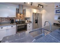 Updated kitchen features granite counters, stainless steel appliances and breakfast bar at 2146 W Isabella Ave # 154, Mesa, AZ 85202