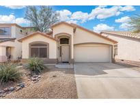 Charming single-story home featuring a two-car garage and desert landscaping for low maintenance at 2523 W Running Deer Trl, Phoenix, AZ 85085