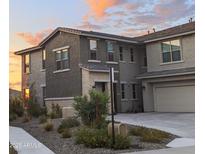 Charming two-story home boasts manicured landscaping and a warm, inviting facade at sunset at 5100 E Rancho Paloma Dr # 1044, Cave Creek, AZ 85331