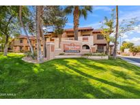 Beautiful condo community entrance with lush landscaping and mature shade trees at 5757 W Eugie Ave # 1080, Glendale, AZ 85304