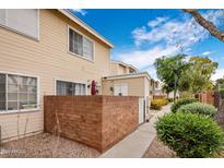 Charming townhome exterior with a brick patio, beige siding, and a well-maintained landscape at 625 S Westwood -- # 121, Mesa, AZ 85210