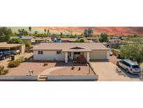 Charming single-story home featuring desert landscaping, a covered front porch, and a two-car garage at 809 N 95Th St, Mesa, AZ 85207
