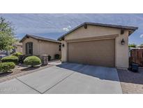 Charming single-Gathering home showcasing a well-maintained two-car garage and desert landscaping at 1197 W Fir Tree Rd, Queen Creek, AZ 85140