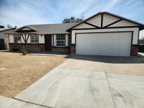 Charming single-story home featuring a large two-car garage and welcoming front yard at 124 S Cottonwood St, Chandler, AZ 85225