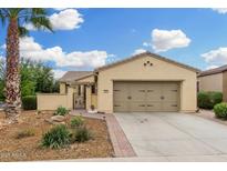 Charming single-story home with a well-manicured yard and a two-car garage at 13051 W Black Hill Rd, Peoria, AZ 85383