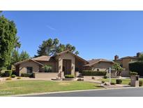 Beautiful single-story home with a well-manicured lawn and desert landscaping at 1348 E Los Arboles Dr, Tempe, AZ 85284