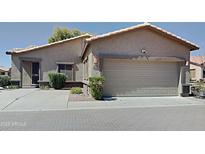 Charming single-story home features a two-car garage, desert landscaping, and a tile roof at 2600 E La Costa Dr, Chandler, AZ 85249