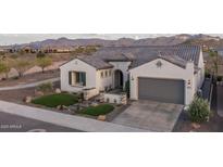 Charming home featuring a tile roof, desert landscaping, and mountain views at 26673 W Ponderosa Ln, Buckeye, AZ 85396