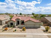 Inviting single-story home with desert landscaping, clay tile roof, and a spacious three-car garage at 4607 E Sierra Sunset Trl, Cave Creek, AZ 85331