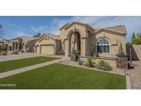 Charming single-story home featuring a well-manicured lawn and a welcoming arched entryway at 5900 W Orchid Ln, Chandler, AZ 85226