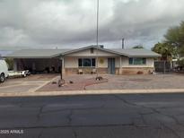 Charming single-story home with a low-maintenance rock front yard at 610 E Estevan Ave, Apache Junction, AZ 85119