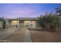 Charming single-story home featuring a covered entry and low maintenance desert landscaping in front yard at 7520 E Papago Dr, Scottsdale, AZ 85257