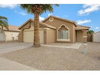 Charming single-story home with desert landscaping and a spacious two-car garage at 881 W Saragosa St, Chandler, AZ 85225
