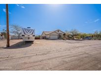 Spacious single-story home with a well-maintained front yard and an RV in the drive at 907 N Mountain Rd, Mesa, AZ 85207