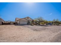 Lovely single-story home featuring a well-kept yard, attached garage, and mature landscaping at 907 N Mountain Rd, Mesa, AZ 85207