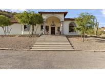 Stunning front exterior of a two-story home with a grand entrance, beautiful landscaping, and a concrete staircase at 1500 N Crismon Rd, Mesa, AZ 85207